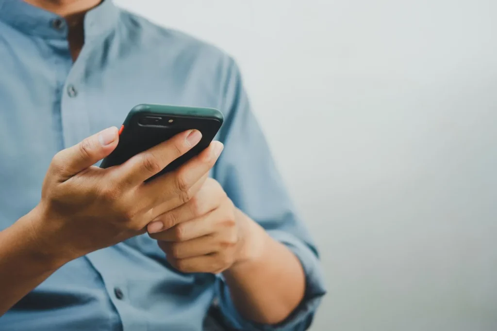 a men hold phone and try to restart phone